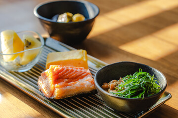 Japanese breakfast with grilled salmon and natto
