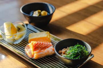 Japanese breakfast with grilled salmon and natto
