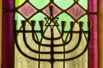 A golden Hanukkah menorah stands in a window in the interior of the Kiever Modern Orthodox synagogue in Toronto, Ontario, Canada.