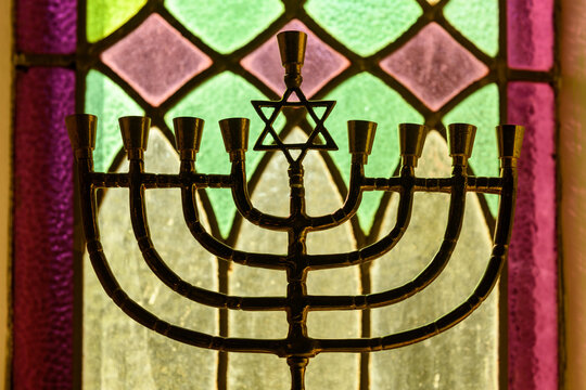 A golden Hanukkah menorah stands in a window in the interior of the Kiever Modern Orthodox synagogue in Toronto, Ontario, Canada.