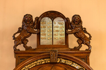 A wooden carving of the tablets of the 10 commandments guarded by upright lions in the Kiever Synagogue in Toronto, Ontario, Canada.