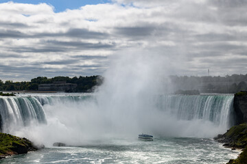 View of the thundering Horseshoe Falls, one of three majestic waterfalls that comprise Niagara Falls on the United States-Canadian border.