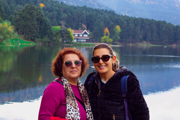 happy family  smiling at camera on the lake 