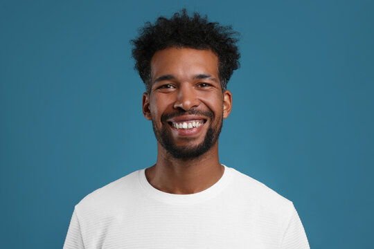 Portrait of happy man on light blue background - Powered by Adobe