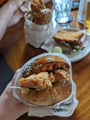 fried crispy chicken sandwich at restaurant with fries 