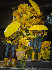 Creative Yellow Flower Installation with Umbrellas and Boots