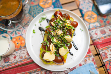 Gourmet avocado toast with cherry tomatoes mozzarella and balsamic glaze
