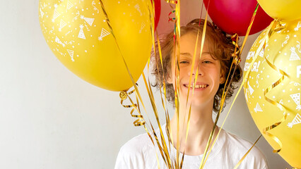 Smiling Teen Surrounded By Yellow And Red Balloons Indoors For Concepts Of Birthday Celebration, Youth Joy, Positive Emotions, Festive Lifestyle Visuals, And Holiday Content For Social Media