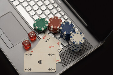 Online Gambling Concept Showing Poker Chips, Cards on Laptop Keyboard