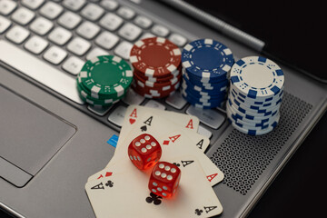 Online Gambling Concept Showing Poker Chips, Cards on Laptop Keyboard