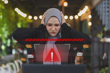 Frustrated Muslim women in hijab reacting to computer virus warning or system error on screen....