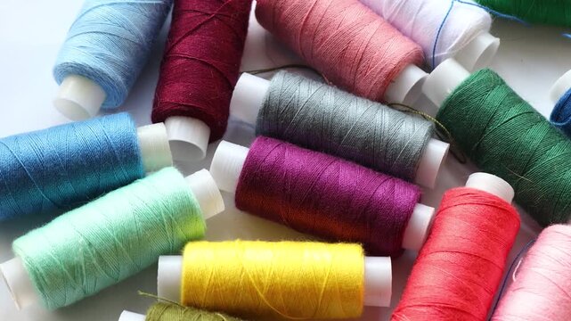 A collection of colorful thread spools arranged neatly on a wooden table