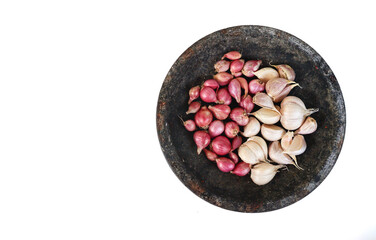 Garlic and red onion or shallots on stone mortar, isolated on white background. 