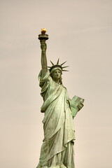 Fototapeta premium Wide-angle shot of the Statue of Liberty as seen from ferry cruising through New York Harbor