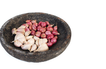 Garlic and red onion or shallots on stone mortar, isolated on white background. 
