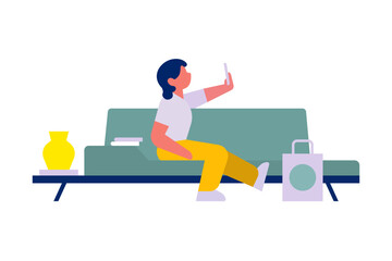 Person sitting on a sofa using smartphone, representing modern lifestyle, digital connection, and comfort in everyday home living.