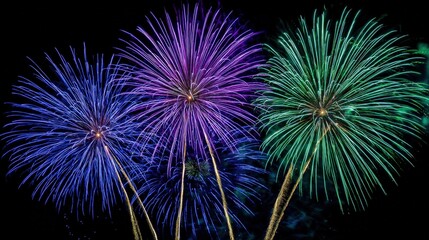 Vibrant Fireworks Display Illuminating the Night Sky with Blue, Purple and Green Explosions