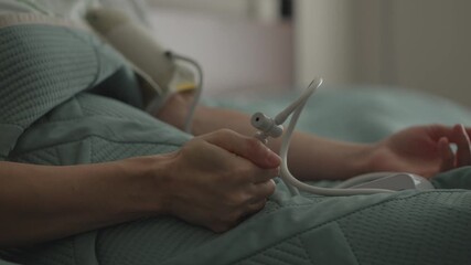 Cardiovascular Diseases. Woman Measures Blood Pressure Lying in Bed in Bedroom. Body Checkup and Tonometer Measures Blood Pressure and Pulse on Woman Arm. Blood Pressure Monitoring Health Care.