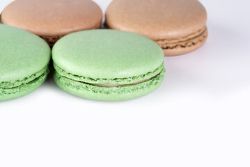 Sweet dessert composition: pastel macaron on light background, copy space.