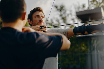 Archery coaching session with focused archer