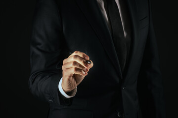 Fototapeta premium Businessman touch with digital pen a futuristic display, write on a virtual screen. Gesture concept