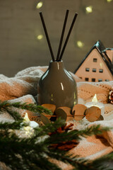 Aroma diffuser with sticks. Cozy winter home. Perfume, aromatherapy with Christmas scent.