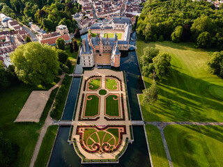 Aerial shot of Château de Maintenon in Maintenon, France, showcasing the château and its meticulously designed formal French gardens from above.

