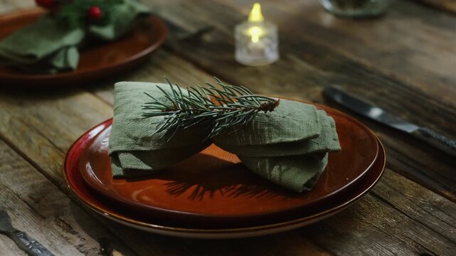 Christmas table setting. Woman preparing crockery for Christmas dinner.