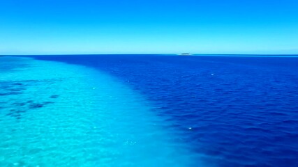 Serene ocean view showcasing vibrant blue waters meeting a clear sky, ideal for travel promotions