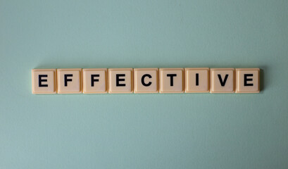 Effective word with alphabet cubes isolated on Light Blue Background
