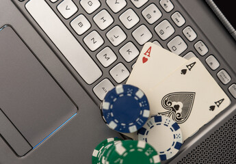 Online Gambling Concept Showing Poker Chips, Cards on Laptop Keyboard