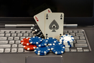Online Gambling Concept Showing Poker Chips, Cards on Laptop Keyboard