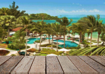 Wooden table top on the beach or sea. swimming pool Party on the beach  sunshine time concept.For montage product display or design key visual layout.View of copy space.