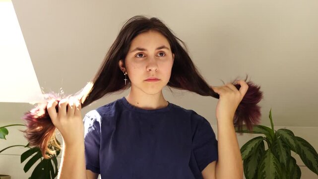 Teenager girl masking akne looking at the mirror