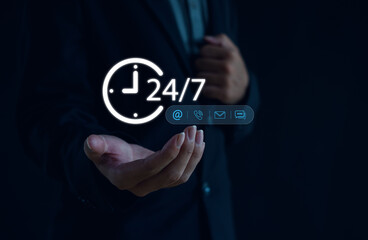 24-7 customer service and communication technology concept showing businessman holding glowing icons of email, phone, and chat for online support and assistance.