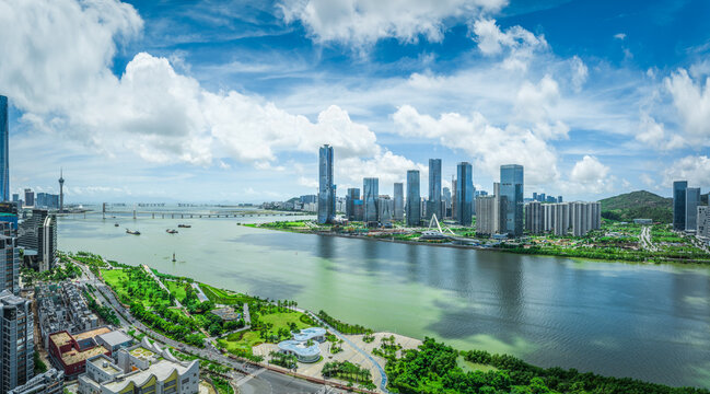 Modern financial district skyline of a new city with green parks and a riverfront on a beautiful sunny day in Zhuhai.