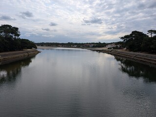 River Boudigau in Hossegor, France on a cloudy morning, mirror reflection in the water