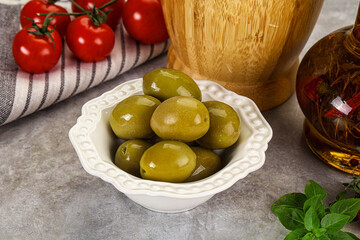 Big green marinated olives in the bowl