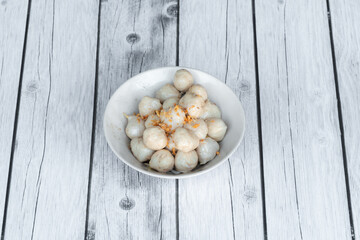 Grilled meatballs skewer bamboo on white plate