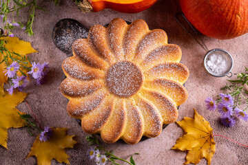 Pumpkin pie for breakfast. Delicious pie for dessert. Autumn pumpkin pie on a brown background. Top view. Close-up