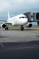Charter airline airplane preparing for flight on airport runway with connected jet boarding bridge