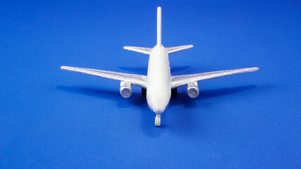 Model airplane on blue background, showcasing details of aircraft design and structure for aviation enthusiasts and hobbyists
