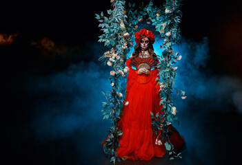 Fantasy goddess woman sugar skull face make-up art paint black white red color, hand holding fan....