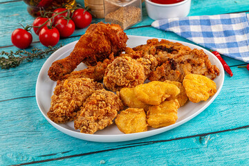 Golden crispy fried chicken mix - wings, drumsticks, nuggets and strips