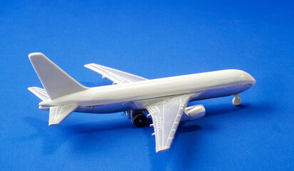 Model airplane on a blue background showcasing intricate details of aviation design
