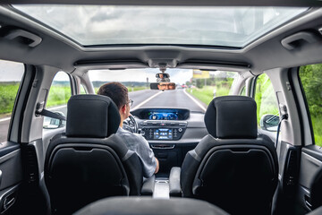 Driver on the road inside modern car. Travel and freedom.