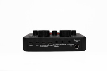 Obraz premium Compact, black audio interface with multiple buttons, knobs, input, and output ports isolated on white background. It's audio sound card for music equipment and recording, easy to use.