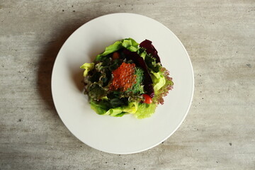 A beautifully presented fresh salad on a pristine white plate, healthy food, appetizing and culinary delight