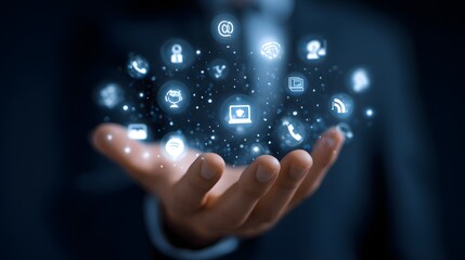 Business professional holding a floating cluster of glowing digital interface icons above open palm