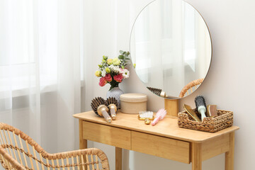 Hair styling. Different combs and brushes on wooden vanity indoors